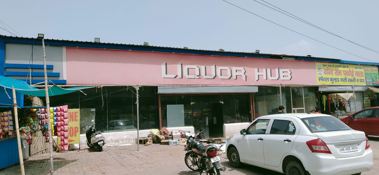 Woodnote Brand Shop Bahadurgarh retail liquor store interior by Next BC